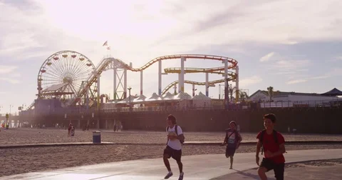 Slow motion of people running at Santa Monica Pier. Stock Footage 73336669