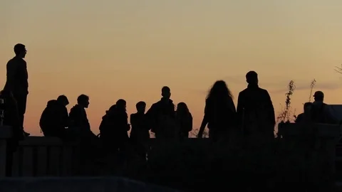 Slow Motion: People Silhouettes against the sky at sunset Stock Footage