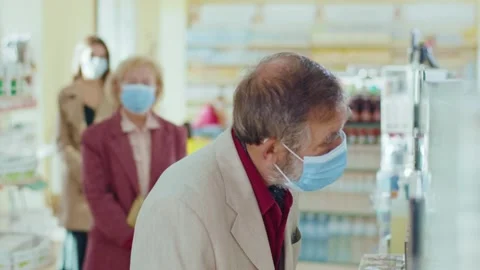 Slow motion people standing in line in the pharmacy. In medical masks. Inside Stock Footage 140763477