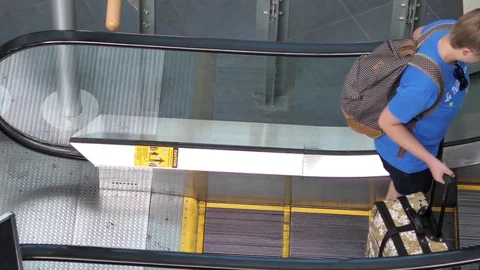 Slow motion of people taking escalator at international arrival lobby Video stock 80435961