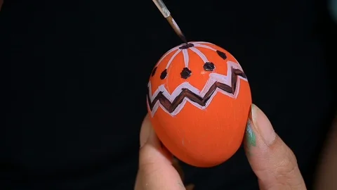 Slow motion, people using brush painting purple pattern design on easter egg  Stock Footage 124542648