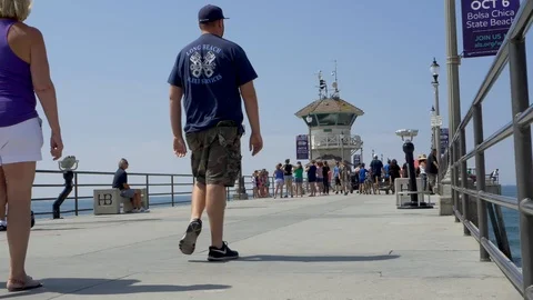 Slow motion people walking at Huntington Pier Stock Footage