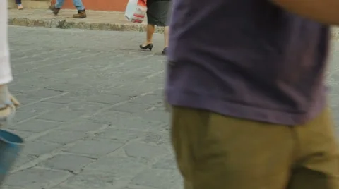 Slow motion of people walking on a stone street Video stock 63650832