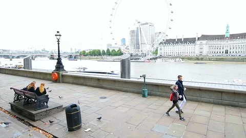 Slow motion of people walking by Thames river, London Eye Stock Footage 97790749