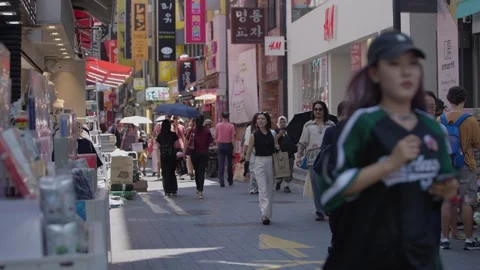 Slow motion of people walking through Myeongdong shopping street in Seoul Stock Footage 314519011