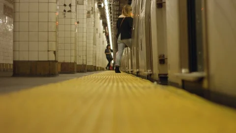 Slow motion of people walking into train at subway station Stock Footage 85577753