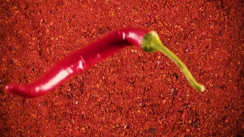 Slow motion pepper pods fall on powder top view Stock Footage 92854336
