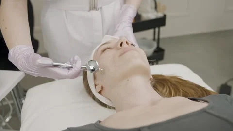 Slow motion permanent makeup application on a woman in a serene beauty salon Stock Footage 319827346