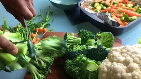 Slow motion of person chopping broccoli for vegan dish- 8 sec Stock Footage 126907758