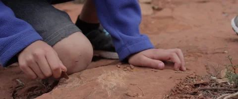 Slow Motion Person Draws on the Desert Ground with an Arrowhead Stock Footage 61834288