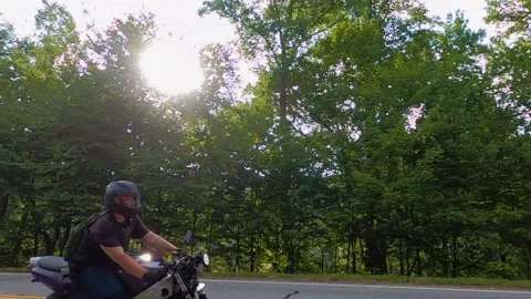 Slow motion of a person passing by on a motorcycle Stock Footage 149260972