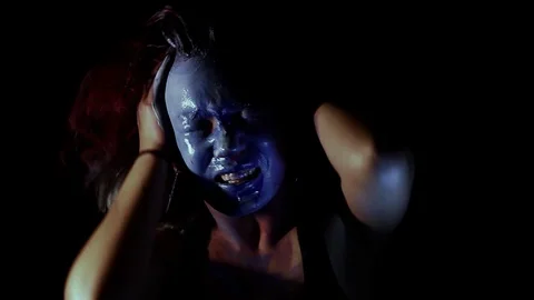 Slow motion of Person screaming while making odd movements as they smear makeup Stock Footage 122725055