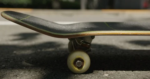 Slow motion of person using skateboard and riding away on sunny street Stock Footage 124716871