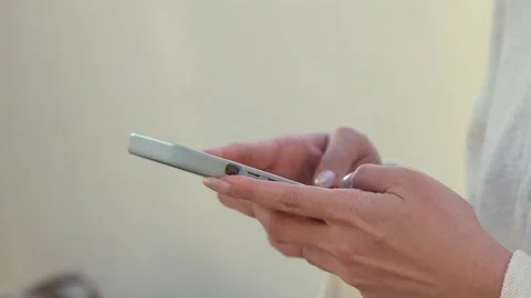 Slow motion of person using a smartphone texting outdoors at a mall Stock Footage 299083097