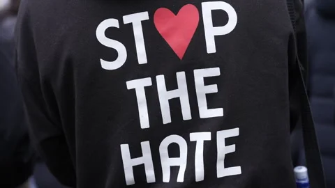 In Slow Motion A Person Wears A T-Shirt That Reads “Stop The Hate” Stock Footage 303203940