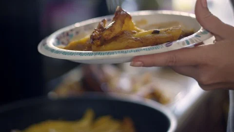 Slow motion of person's hands frying sweet plantains Stock Footage 113939603