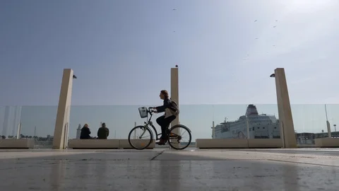 Slow motion of persons riding a bicycle, running, and walking Stock Footage 103690762