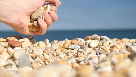 Slow motion picking up and dropping stones Stock-Footage 77436157