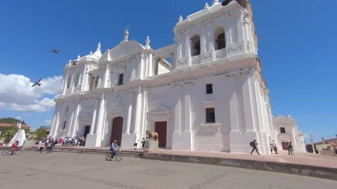 Slow Motion pigeons fly off of white cathedral building Leon Nicaragua Stock Footage 130301962