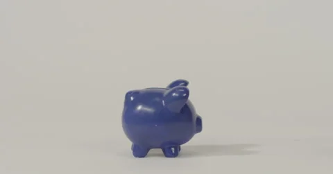 Slow motion of a piggy bank being smashed to pieces with a hammer Stock Footage
