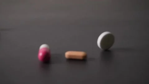 Slow motion of pills falling on a table Stock Footage 160547949