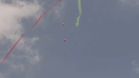 Slow Motion Pink balloons hovering in air with confetti Stock Footage 78573461