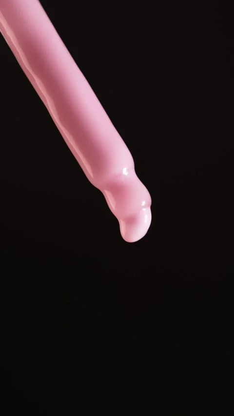 Slow Motion Pink Cream Drop from Pipette  Macro Vertical Beauty Shot Stock Footage 312762786