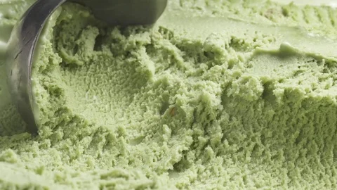 Slow motion of pistachio ice cream being scooped close up Stock Footage