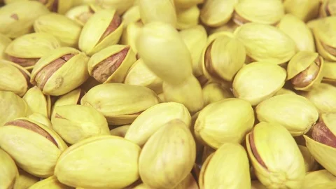 Slow motion pistachios fall on pistachios Video stock 95395740