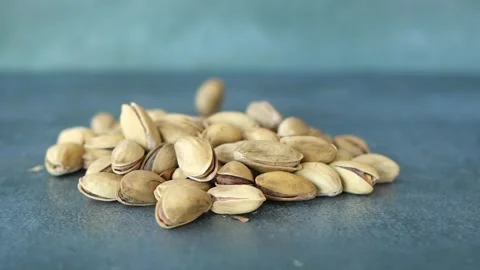 Slow motion of pistachios nut dropping on black background Stock Footage 296620126