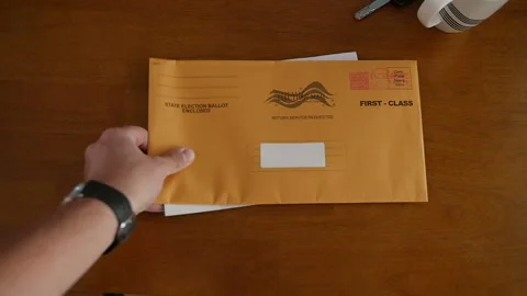 Slow Motion Placing Election Mail In Ballot on Table at Home Stock Footage 139359197