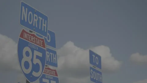 Slow motion of plane flying with highway 85/75 signs Stock-Footage 133544255