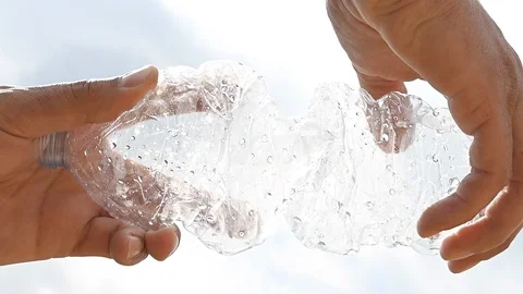 Slow motion of a plastic bottle crushed by the hands  man Stock Footage 105816428