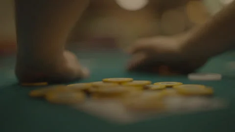 Slow motion player bringing yellow chips onto his cards Видео 334037269