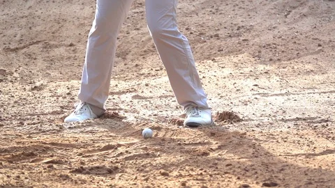 Slow motion player swing ball on sand bunker. Golfer playing golf ball in course Stock Footage 92043726