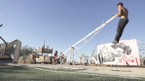Slow Motion Playing on Art Installation Seesaw Stock Footage 98457946