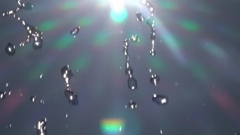 Slow motion of playing water, falling and dripping with sun and lens flare. Stock Footage 100237357