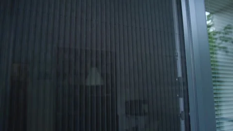 Slow motion of a pleated mosquito net on a window reveals fine vertical mesh Stock Footage 340956791