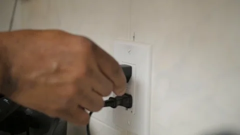 Slow Motion Plugging into Outlet Stock Footage 115506136