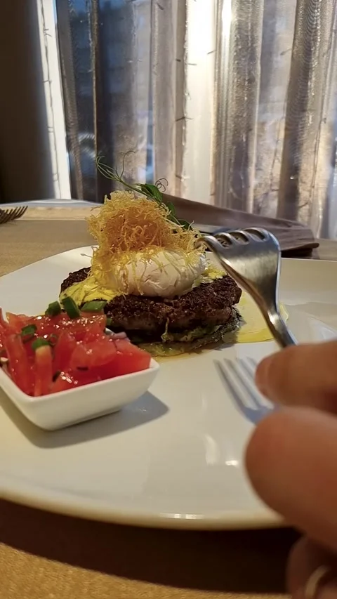 Slow motion poached egg cut on beef steak vertical Stock Footage 311113104