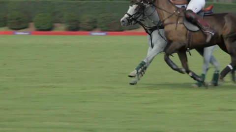 Slow motion- polo players chasing the ball down field Stock Footage