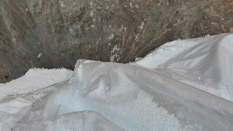 Slow motion of polystyrene beads pouring and being vacuumed Stock Footage 340276522