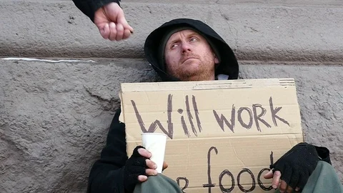  Slow motion. Poor Man with cardboard, passerby  gives alms. Focus approach Stock Footage 71407575