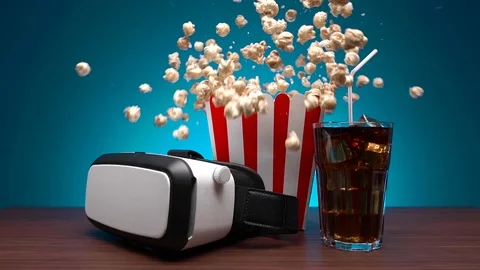 Slow motion popcorn flying out of the box. A virtual reality headset, a box of 库存影片 102276928