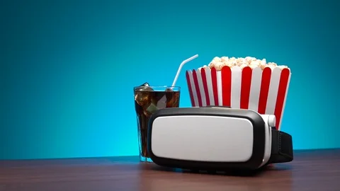 Slow motion popcorn flying out of the box. A virtual reality headset, a box of Stock Footage 102276933