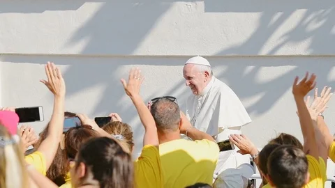 Slow motion of Pope Francis at St Peter's square riding popemobile, blessing Stock Footage