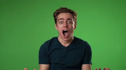 Slow motion portrait of amazed young man 20s shocked, saying WOW. Handsome guy Stock Footage 223524445