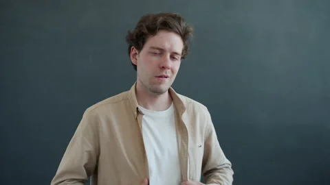 Slow motion portrait of arrogant guy showing thumbs-up hand gesture and pointing Stock Footage 150548453