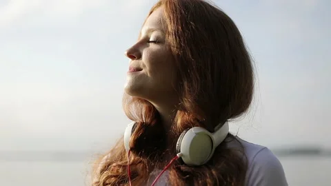 Slow motion. Portrait of dancing young happy woman with red curly hair with Stock Footage 118948354