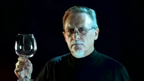 Slow motion. Portrait of an elegant mature sommelier tastes expensive wine. Stock Footage 136942833